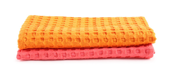 Folded colorful kitchen towels on white background