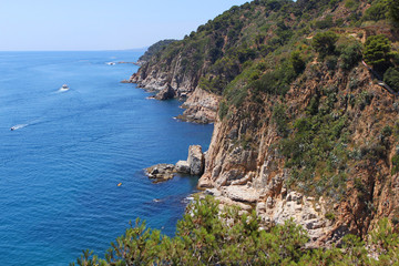 Fototapeta na wymiar coast blue mediterranean sea with rocks and mountains covered with trees