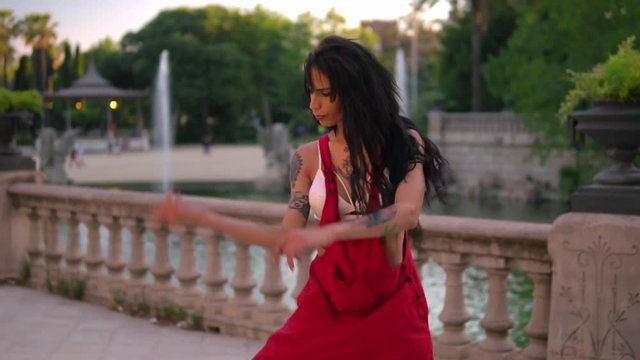 tattooed transgender model is dancing in the green park. Emotional dance movements
