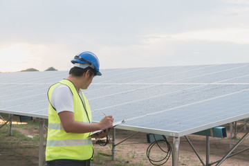 worker checking solar panel in the field.