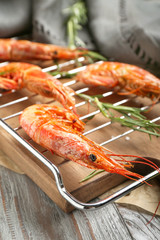 Cooling rack with tasty shrimps on table