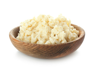 Bowl with shea butter on white background