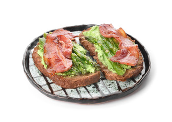 Plate with tasty toasts on white background
