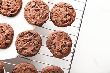 Tasty chocolate cookies on cooling rack