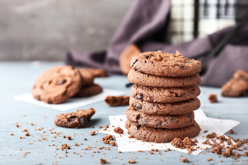 Stack of tasty chocolate cookies on table