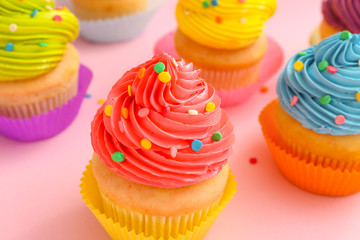 Sweet tasty cupcakes on color background