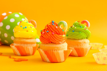 Sweet tasty Birthday cupcakes on color background