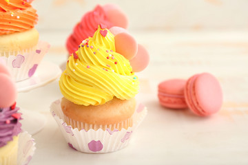 Sweet tasty cupcake on light table