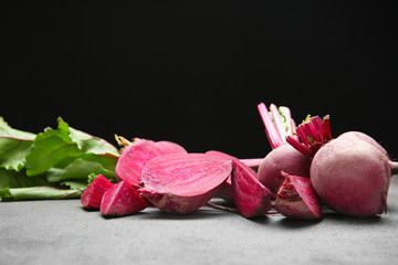 Fresh beet on grey table against dark background