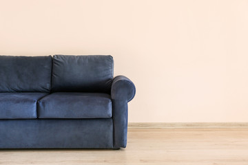 Soft sofa near light wall in living room
