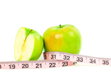Dieting. Fresh green apple and measuring tape on white background.
