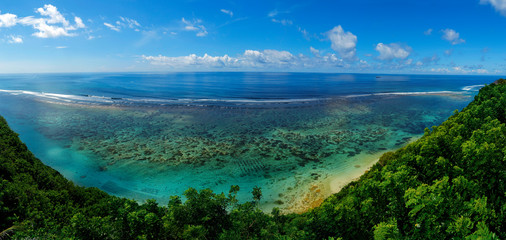 view of the coast with beach and coral at bukit in bali -indonesia