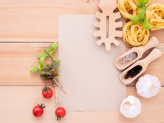 Naklejka na ściany i meble Italian foods concept and menu design . The ingredients for homemade pasta with copy space on wooden background.