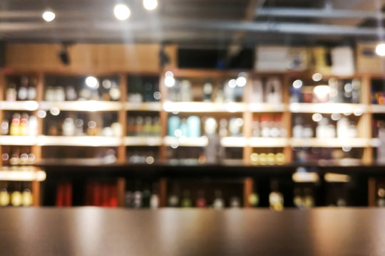 Background blur of wine shelf rack at retail store