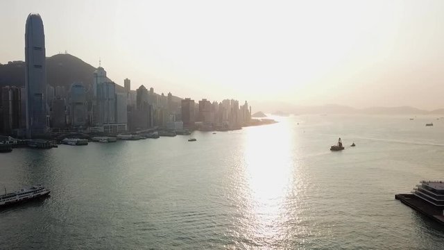 Aerial: Hong Kong Waterfront with Iconic Skyline and Victoria Harbor at Sunset