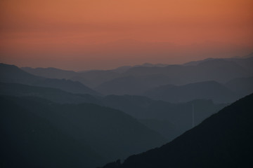 layers of hills in the sunset with Trbovlje chimney - Slovenia