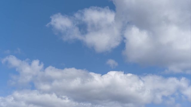 Beautiful blue sky with white clouds rolling by. Time lapse clouds, rolling puffy cloud are moving. Cloud running across the blue sky. Timelapse of white clouds with blue sky in background.