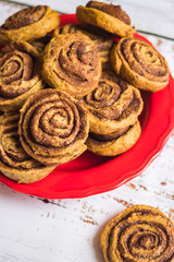 Cinnamon roll or cinnamon bun - sweet baked dessert with spices, flour, sugar and butter.