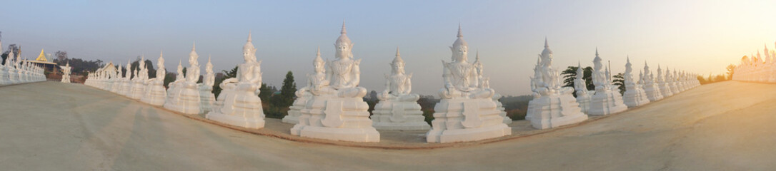 Fototapeta na wymiar white buddha statue row with sunlight