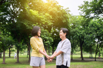 Fototapeta premium Take care and support concept,Portrait of elderly asian woman with daughter hand holding together,Elderly health insurance