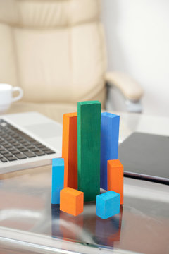 Set of wooden blocks of various height and color used as diagram