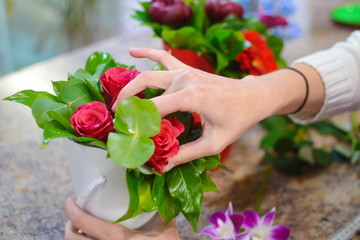Florist at work. Working tool of the florist. Concept of flower shop. Woman collects a beautiful bouquet of flowers. Flower beautiful background