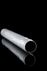 Food stretch film in a roll on a black background, isolate with reflection on the glass