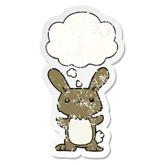 cute cartoon rabbit and thought bubble as a distressed worn sticker