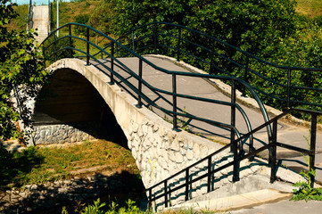 Stone Bridge over little river in the city park