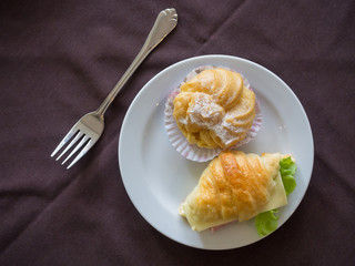 Breakfast of Fresh croissant sandwich with cheese and vegetables