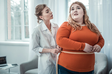 Cheerful longhaired woman visiting her professional dietician