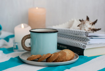 A study break: a mug of tea with cookies on a side.