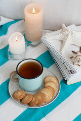 A study break: a mug of tea with cookies on a side.