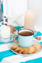 A study break: a mug of tea with cookies on a side.