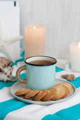 A study break: a mug of tea with cookies on a side.