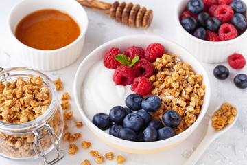 High protein and diet breakfast. Homemade granola crisp with raspberry, blueberry and greek yogurt.