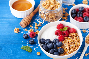 High protein and diet breakfast. Homemade granola crisp with raspberry, blueberry and greek yogurt.