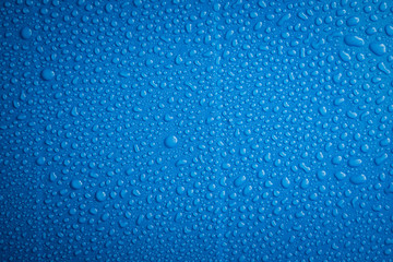 Close up water drops blue background