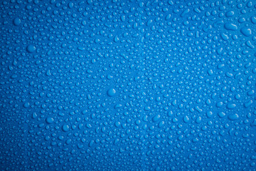 Close up water drops blue background