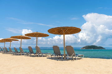 Beach chairs with umbrella with blue sky