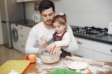 Family in a kitchen. Handsome father with litle daughter