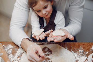 Family in a kitchen. Handsome father with litle daughter