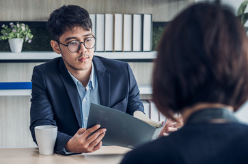 interviewer see qualification of interview candidate that apply for job at meeting room in office