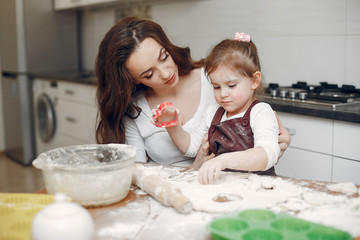 Family in a kitchen. Beautiful mother with little daughter