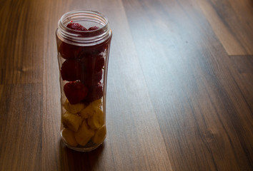 a ingredients for banana and strawberry smoothies in a jar