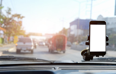Cropped shot view The driver uses the phone while driving. Modern smart phone with round edges....