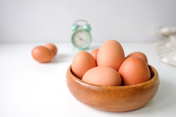 Fresh eggs from the farm placed on a white wooden table background