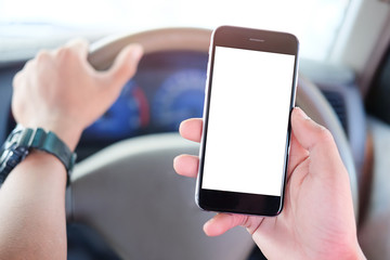 Cropped shot view The driver uses the phone while driving. Modern smart phone with round edges. Isolated screen for mockup. Car navigation display in background.