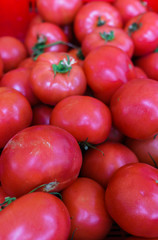 Fresh, red tomatoes in a wooden box in the store.