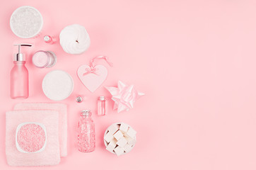 Modern exquisite set of cosmetic products and accessories in pastel pink color, copy space, flat lay.